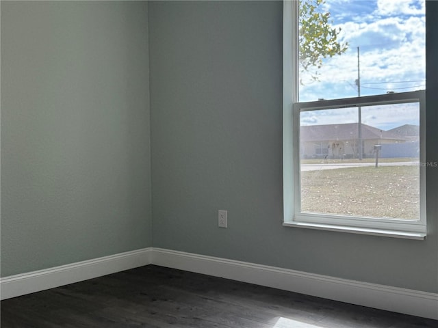 empty room with dark hardwood / wood-style floors