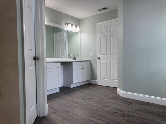 bathroom with hardwood / wood-style flooring and vanity