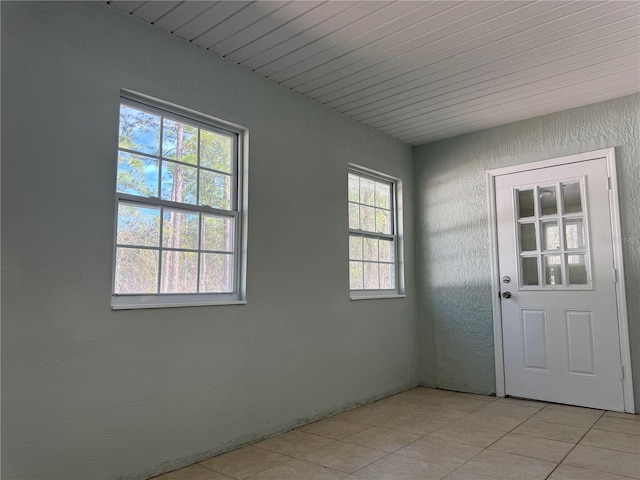 doorway with light tile patterned floors