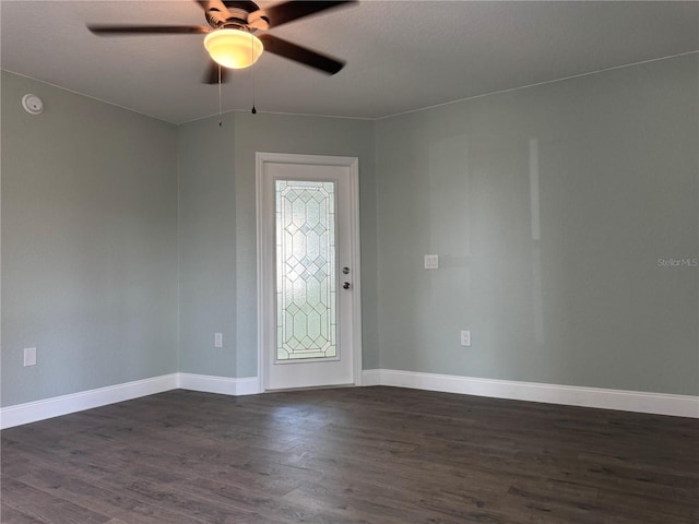 unfurnished room with dark hardwood / wood-style floors and ceiling fan