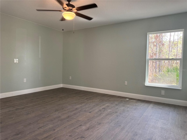 spare room featuring ceiling fan and dark hardwood / wood-style flooring