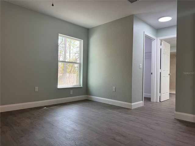 unfurnished room featuring dark hardwood / wood-style flooring