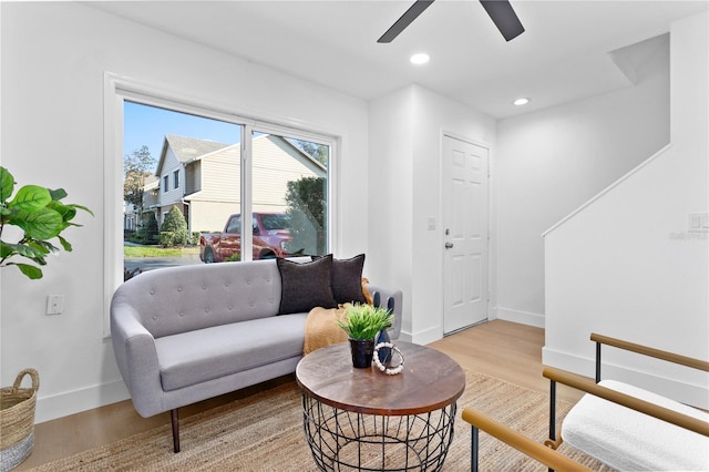 living room featuring ceiling fan and light wood-type flooring