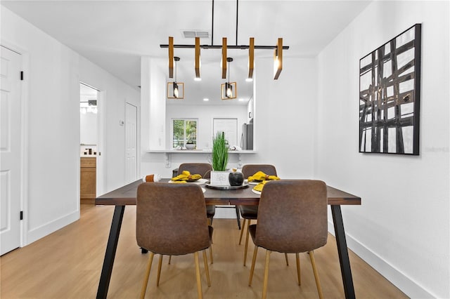 dining space with light hardwood / wood-style floors