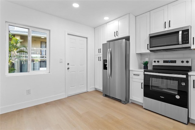 kitchen featuring white cabinetry, stainless steel appliances, and light hardwood / wood-style floors