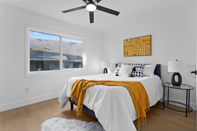 bedroom with hardwood / wood-style flooring and ceiling fan