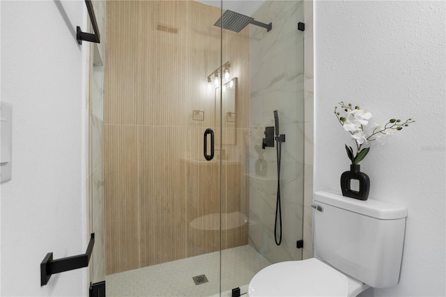 bathroom featuring walk in shower and toilet