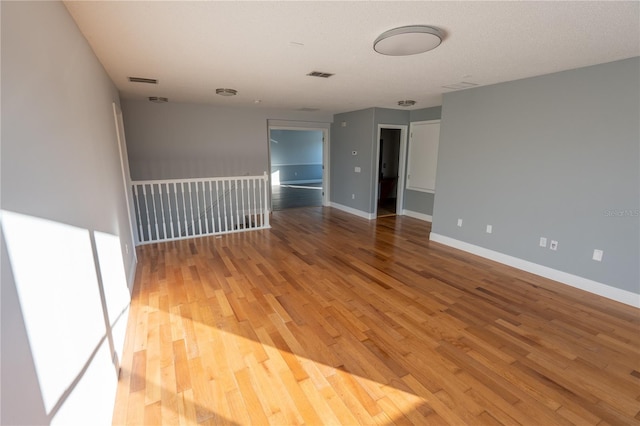 empty room with hardwood / wood-style flooring