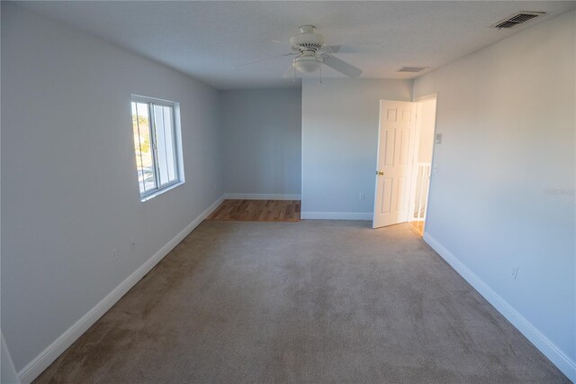 unfurnished room with light colored carpet and ceiling fan