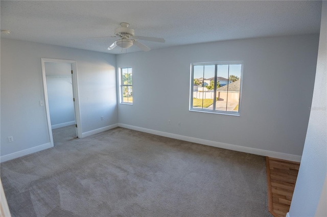 spare room with light colored carpet and ceiling fan