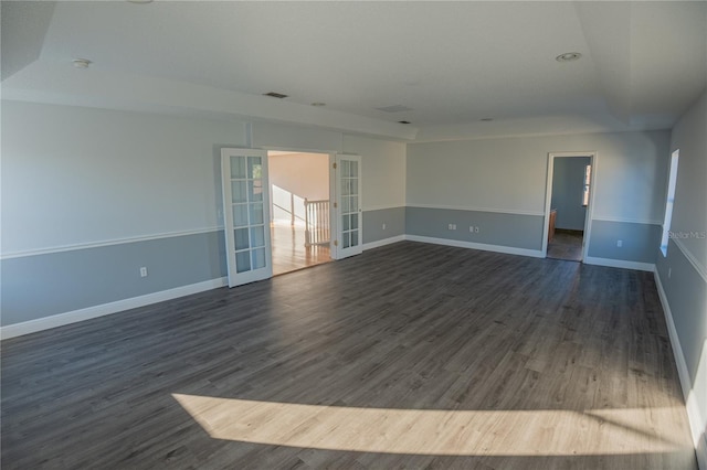 unfurnished room featuring dark hardwood / wood-style flooring and french doors