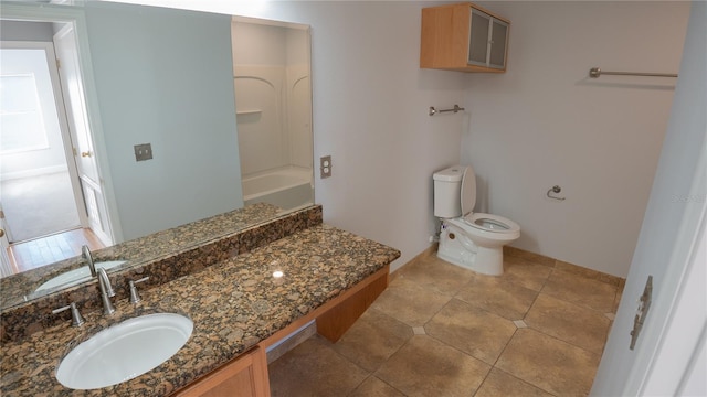 bathroom featuring vanity, tile patterned floors, and toilet