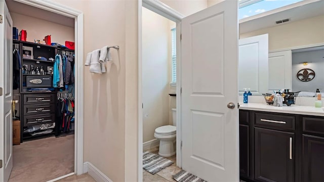 bathroom featuring vanity and toilet