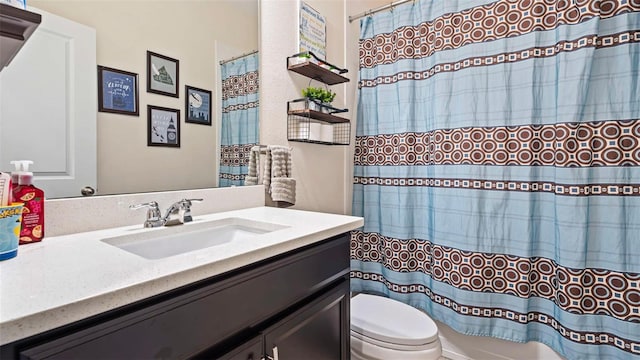 bathroom with vanity, toilet, and a shower with shower curtain