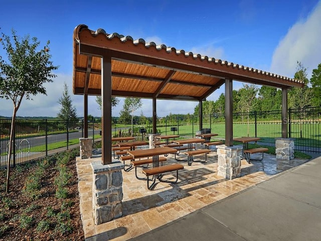 surrounding community with a gazebo, a yard, and a patio