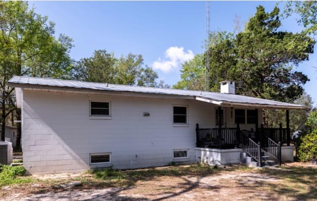 rear view of property featuring a porch