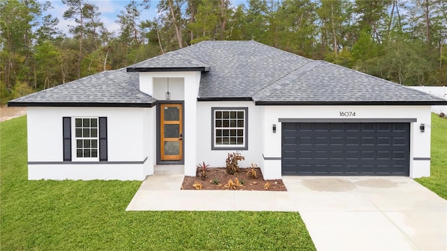 view of front of property with a garage and a front lawn