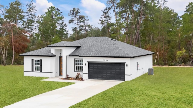 view of front facade featuring a garage, central AC, and a front lawn