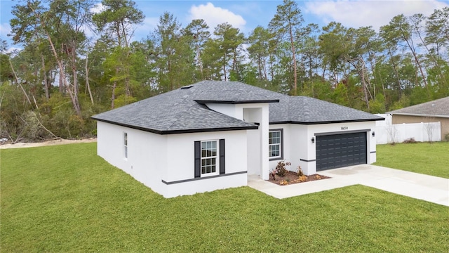 view of front of home featuring a garage and a front lawn