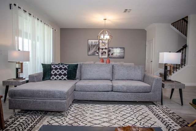 living room featuring wood-type flooring and a notable chandelier