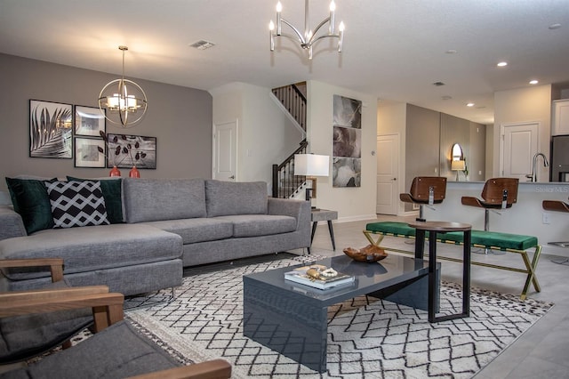 living room with a notable chandelier and sink