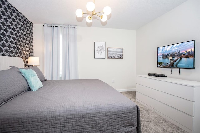 carpeted bedroom with a notable chandelier and a textured ceiling