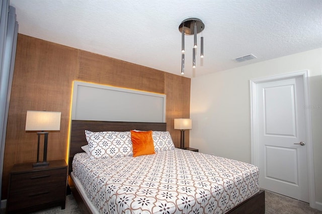 carpeted bedroom featuring a textured ceiling