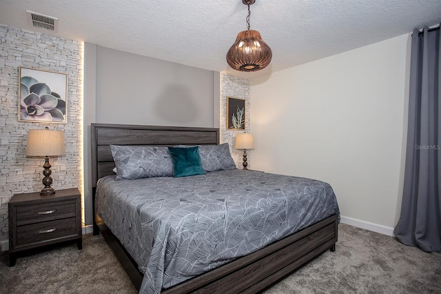 bedroom featuring carpet floors and a textured ceiling