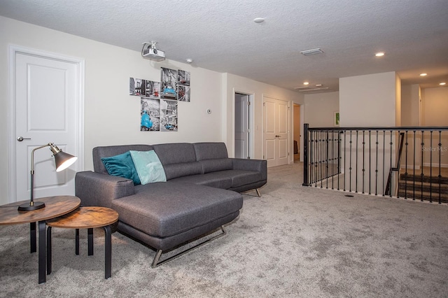 carpeted living room with a textured ceiling