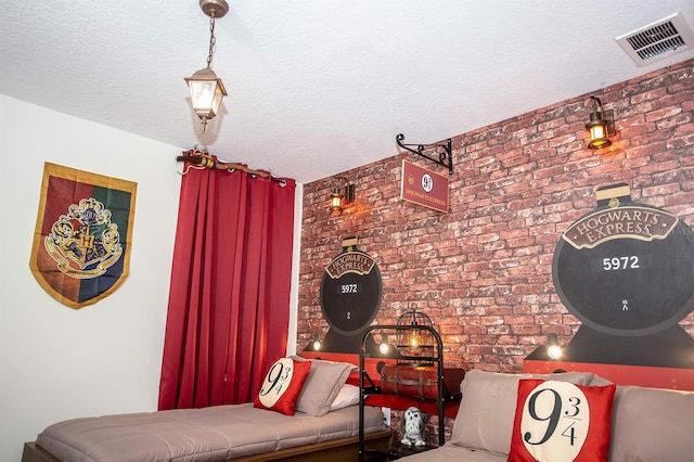 interior space featuring brick wall and a textured ceiling