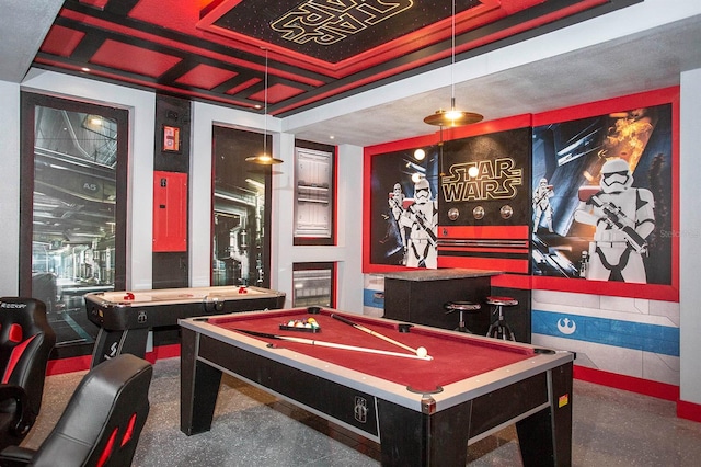 recreation room with billiards, bar area, and a tray ceiling