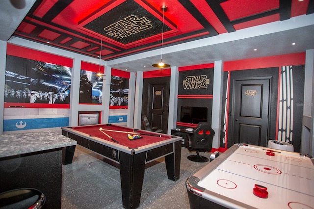 playroom with a tray ceiling and billiards