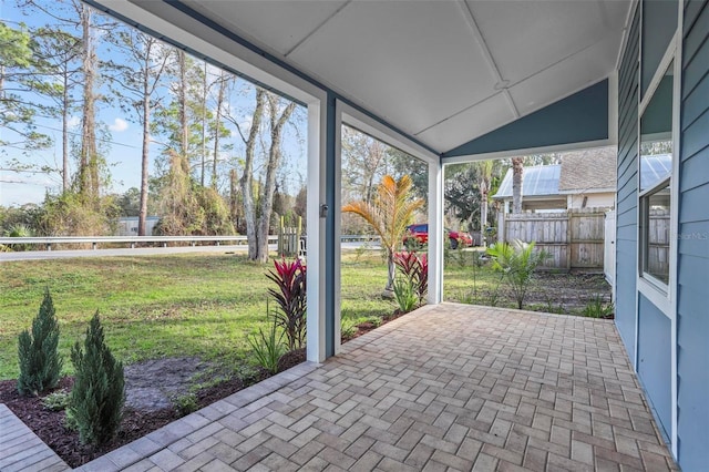 unfurnished sunroom with lofted ceiling