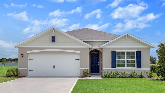 view of front facade with a garage and a front yard