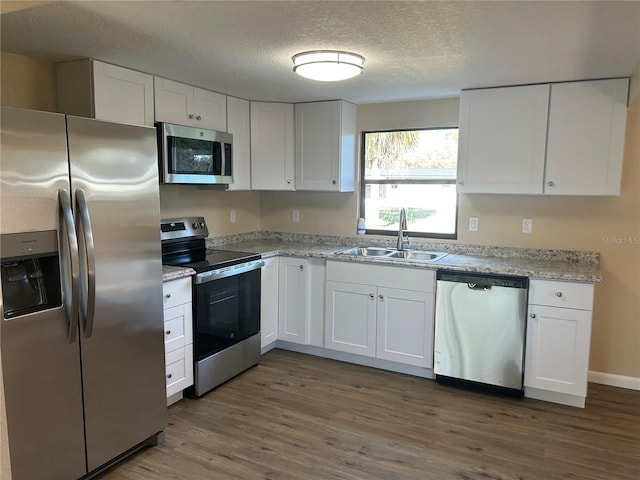 kitchen featuring sink, dark wood-type flooring, white cabinets, and appliances with stainless steel finishes