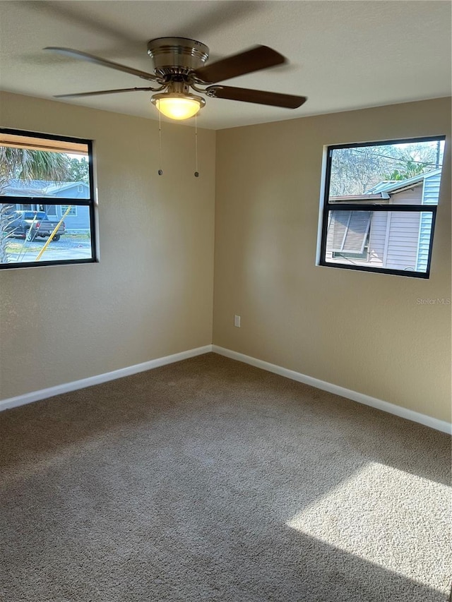 carpeted empty room featuring ceiling fan