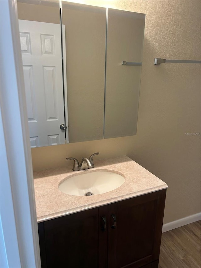 bathroom featuring vanity and wood-type flooring