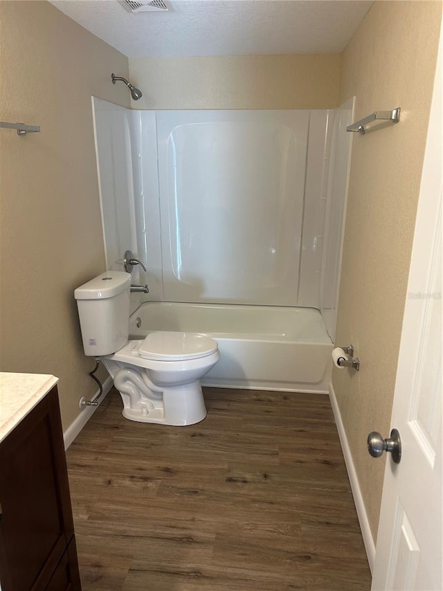 full bathroom featuring vanity, hardwood / wood-style flooring, toilet, and shower / bath combination