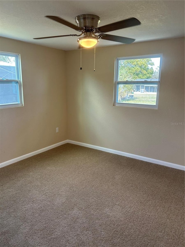 carpeted empty room with a textured ceiling