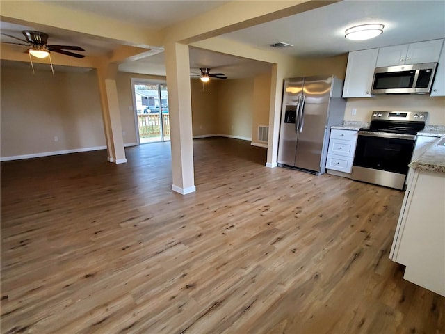 kitchen with ceiling fan, light hardwood / wood-style floors, white cabinets, and appliances with stainless steel finishes