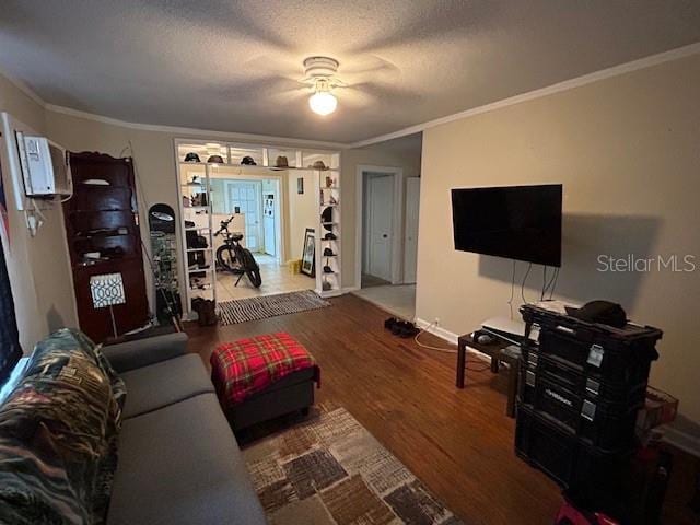 living room with crown molding, hardwood / wood-style floors, and a textured ceiling