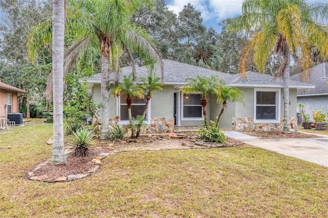 single story home featuring a front yard and central AC unit