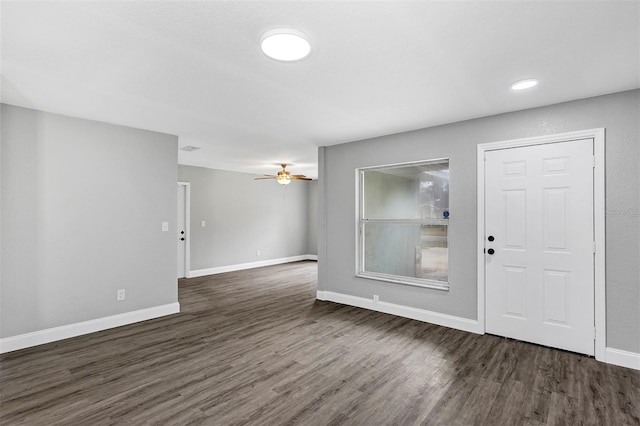 interior space featuring dark wood-type flooring and ceiling fan