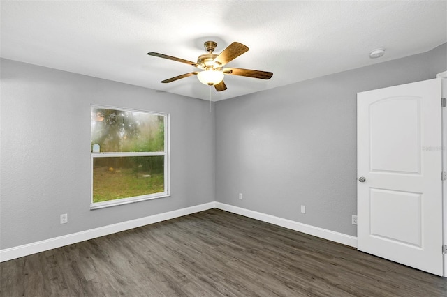 empty room featuring a textured ceiling, dark wood-type flooring, and ceiling fan