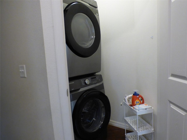 washroom featuring stacked washer and clothes dryer