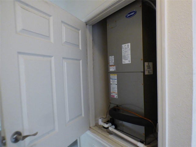 utility room featuring heating unit