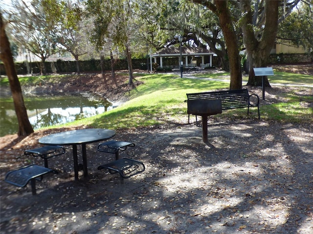 view of property's community featuring a gazebo, a lawn, and a water view