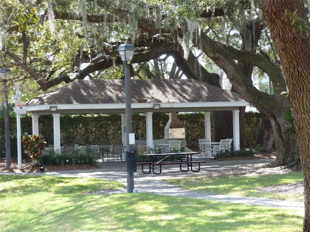 surrounding community with a lawn and a gazebo