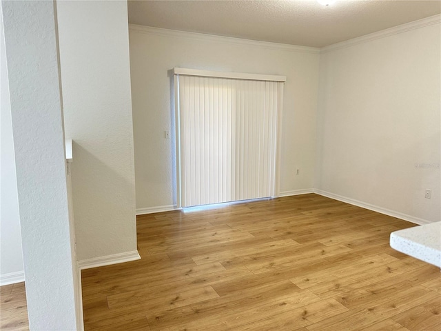 unfurnished room with ornamental molding and light hardwood / wood-style flooring