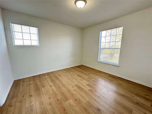 spare room featuring light wood-type flooring